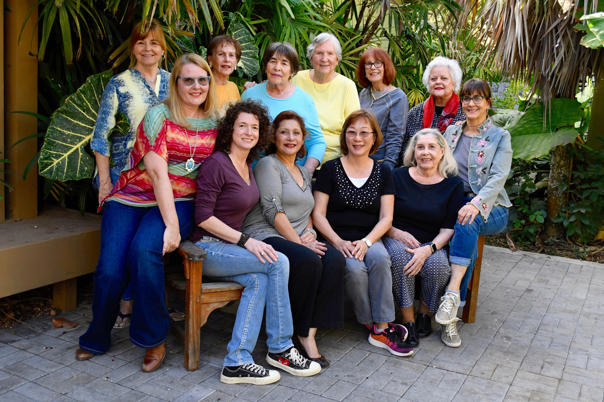 Standing left to right: Lark Ivy, Annie Gonzalez, Susan Feldman, Ardis Bourland, Lorraine Tucker and Magda Martinez. Sitting left to right: Bonnie Masdeu, Alexandra Urvina, MaiYap, Eumelia Castro, Leona Rogers and Ana Sora Vadillo